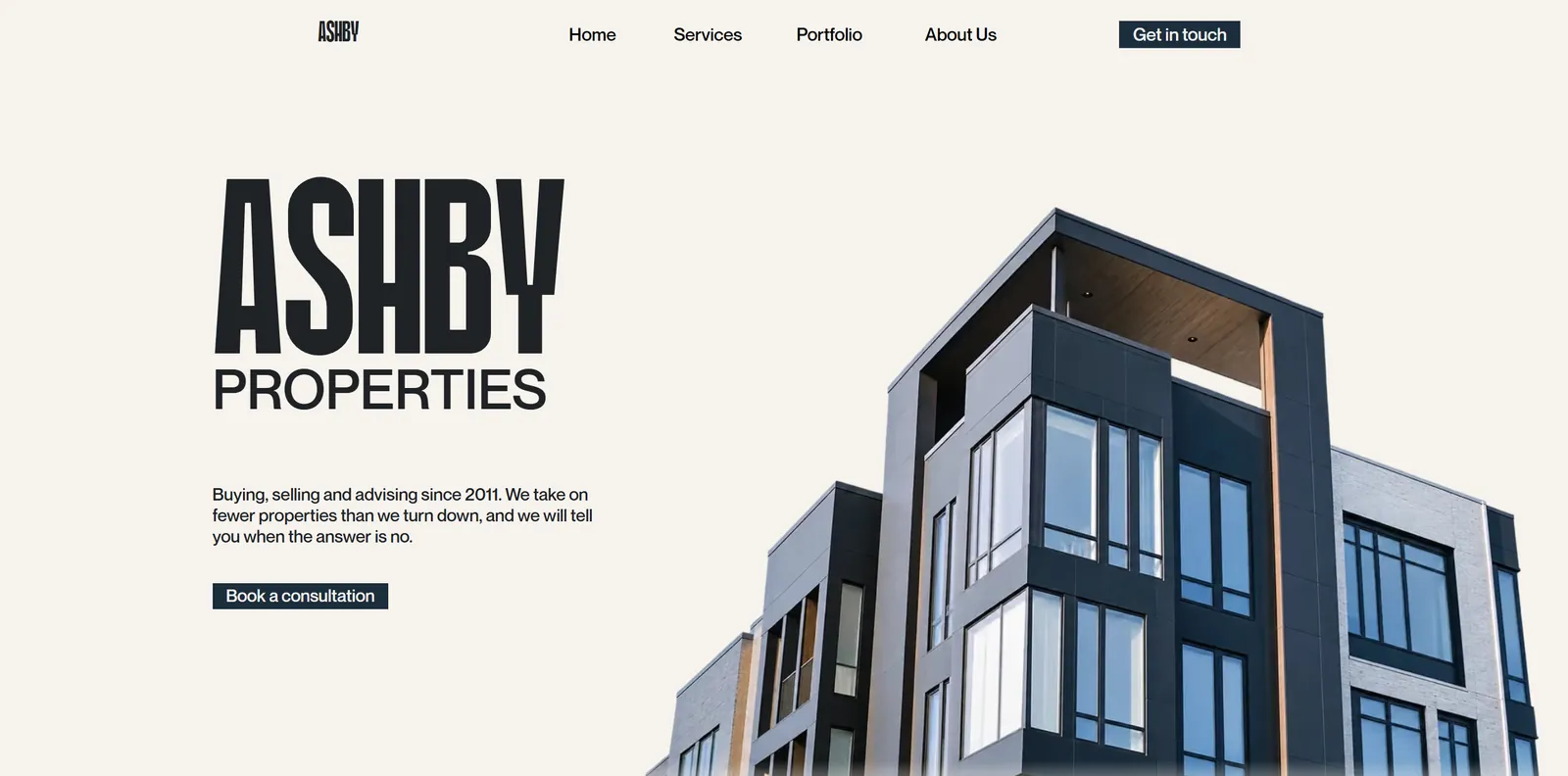Ashby Properties website. The name set in tall condensed type beside an apartment block shot from below.